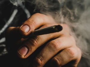 Hand with a joint for cannabis tourism