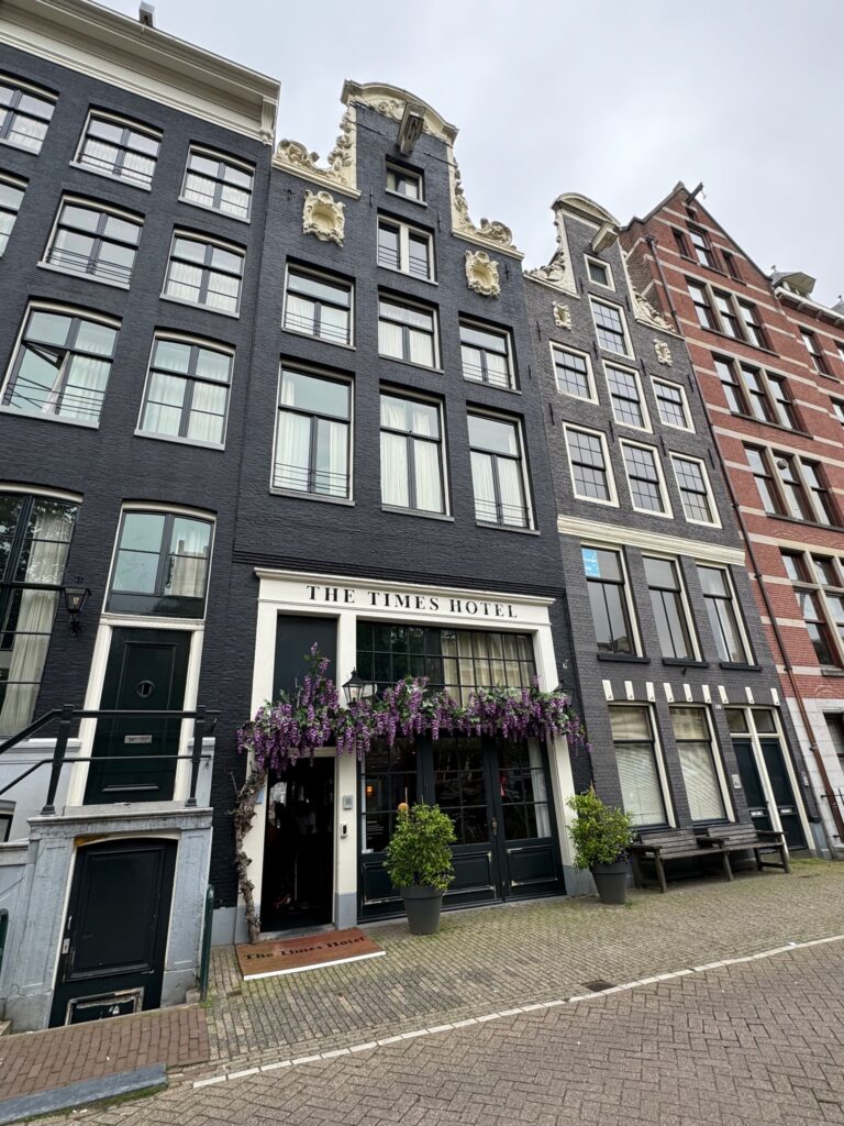 The Times Hotel with beautiful purple wisteria flowers at the entrance