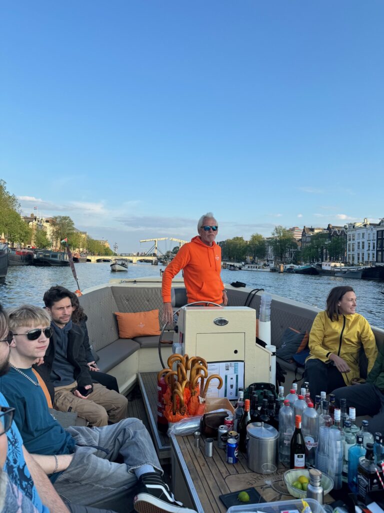 Flagship canal cruise captain steering the boat on an Amsterdam canal
