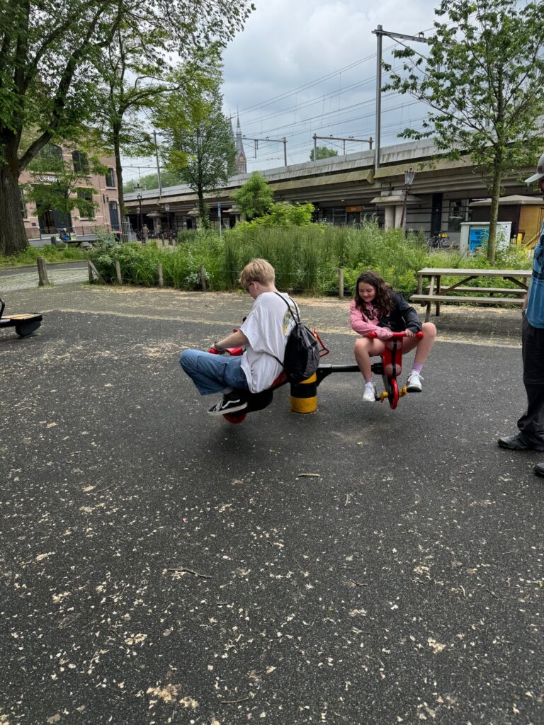 Kids playing in Amsterdam on equipment in the neighborhood square