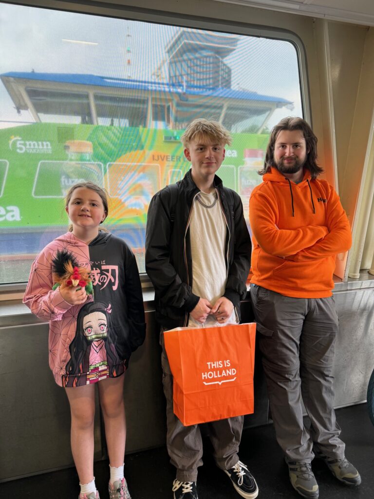 Three kids in front of the This Is Holland Experience